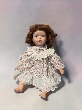 Classic Porcelain Baby Doll in White Floral Dress and brown hair